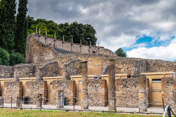 Fototapeta premium Historical ruined building with the Vesuvius mount, Pompeii