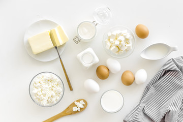 Fototapeta na wymiar Eggs, butter, milk, yougurt, cottage for natural farm products yougurt on white background top view monochrome pattern