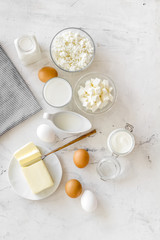 Eggs, butter, milk, yougurt, cottage for natural farm products yougurt on marble background top view monochrome