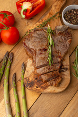 Steak with vegetables on a wooden background, restaurant and hotel business, menu, homemade recipes, culinary background, vertical photo, banner