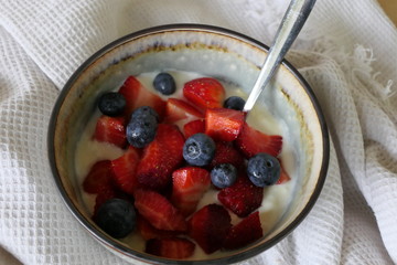 Homemade Yoghurt with Fresh Strawberries and Blueberries on a Wooden Background