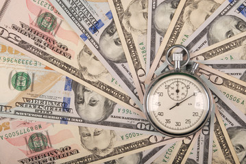Stopwatch on mandala kaleidoscope from money.