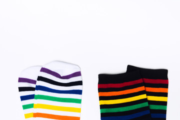 Two clean white and black pair of socks with striped pattern on white background with copy space