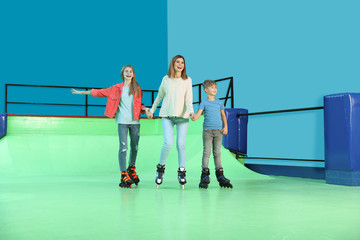 Happy family having fun at roller skating rink
