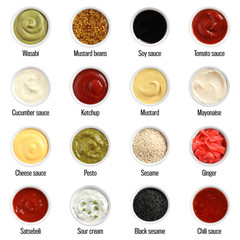 Set of different delicious sauces on white background, top view