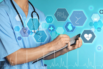Male doctor with stethoscope and clipboard on color background, closeup. Medical objects