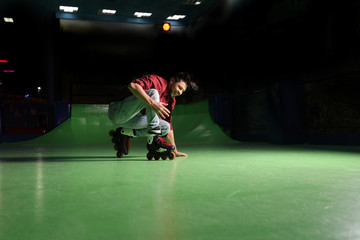 Man having fun at roller skating rink. Space for text