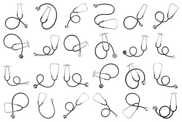 Set of black stethoscopes on white background, top view. Medical device