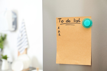 To do list with magnet on refrigerator door indoors. Space for text