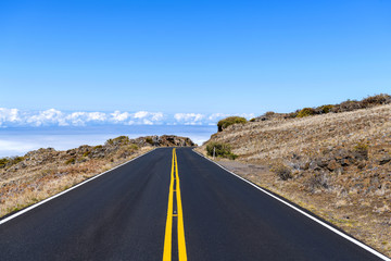 Highway in the Sky - A bright sunny day view of a newly resurfaced section of Haleakala Highway in Haleakala National Park. Maui, Hawaii, USA.