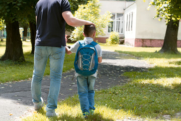 father escorts son to school