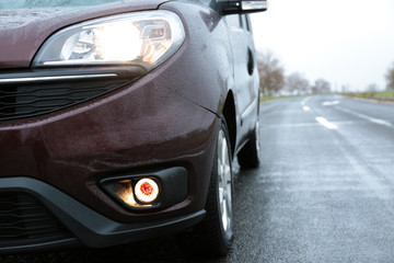 Fototapeta premium Car parked outdoors on rainy day, closeup