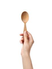 Woman holding clean wooden spoon on white background, closeup
