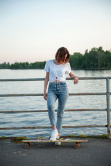 Young hipster girl with longboard