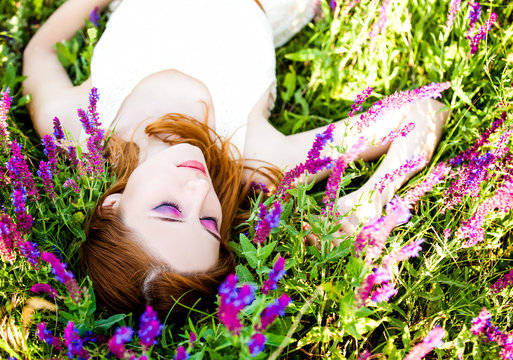 Redhead girl in purple flowers.