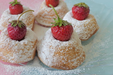 Mini Cakes with Strawberries isolated on a Blue and Pink Background
