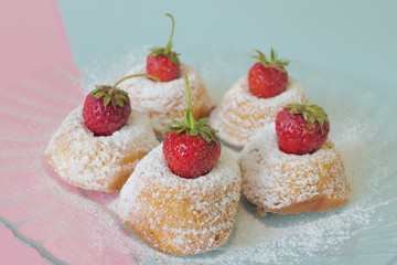 Mini Cakes with Strawberries isolated on a Blue and Pink Background