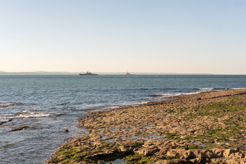 Fototapeta na wymiar The Bugio Lighthouse and a vassal at Tagus Estuary in the morning.