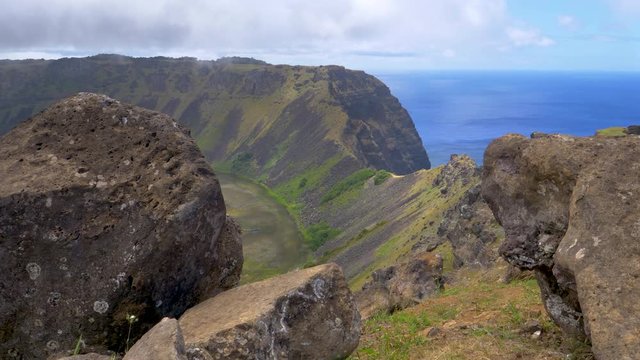 Breathtaking view of a volcanic crater on exotic island filled with small freshwater ponds. Picturesque shot from above of the volcanic rim and the famous Rano Kau crater on a cloudy summer day.
