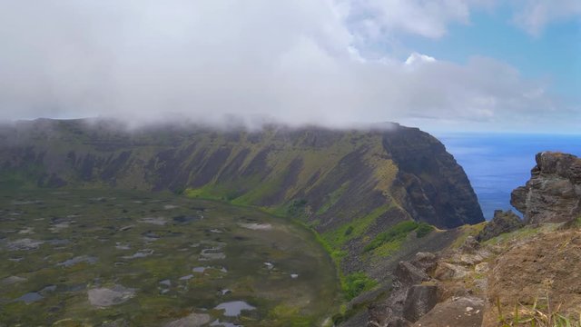 TIMELAPSE: Cinematic shot of a spectacular volcanic crater near the historic village of Orongo. Small freshwater ponds are scattered around the massive crater on a remote exotic island in the Pacific.