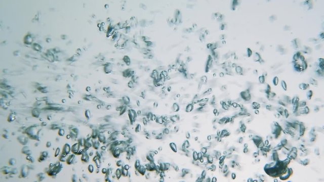 Abstract chaotic air bubbles movement in clear water. Boiling effect