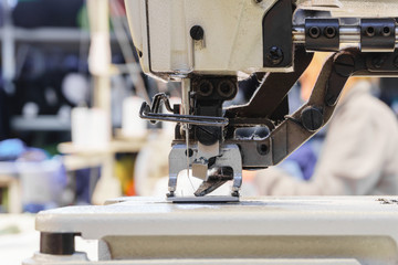 dust on the mechanism of an industrial sewing machine