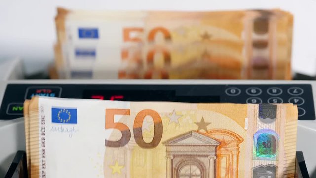 White counting machine checks cash euros.