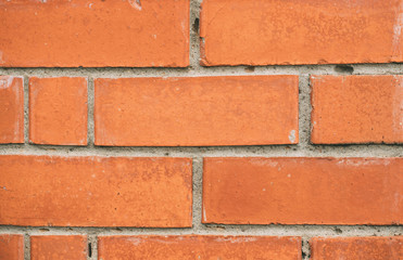 Obraz premium Brick wall texture close up. Orange yellow masonry macro. Brickwork grunge background. Brick laid crookedly.