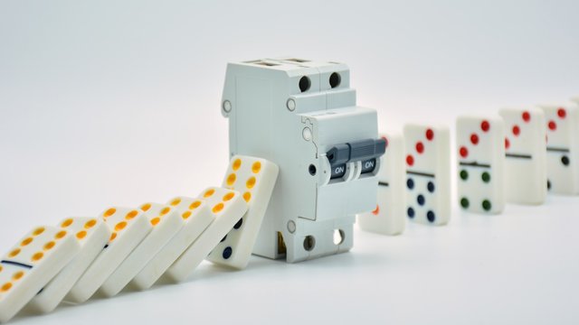 fichas de domin&oacute; cayendo, cortadas con un interruptor el&eacute;ctrico