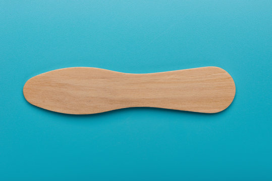 wooden spoon for ice cream sundae on blue background