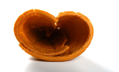 the shell of an ice cream cone shaped like a heart on white background