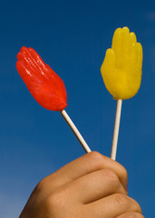 red and yellow lollipops in front of blue sky