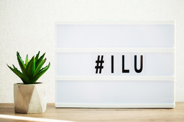 Led letter board with hashtag word on table.