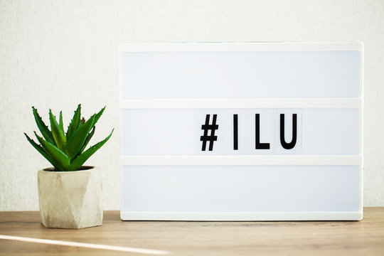Led letter board with hashtag word on table.