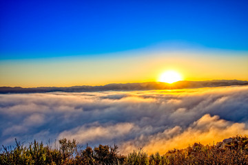 Sunset Above the Clouds in Mountains