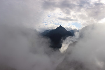 Mountain surrounded by clouds at sunrise