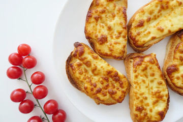 Roasted Cheese Toasts and Cherry Tmatoes in a White Plate