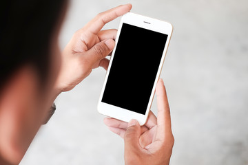 Cropped shot view of man hands holding smart phone with blank copy space screen for your text message or information content, female reading text message on cell telephone during in urban setting. 