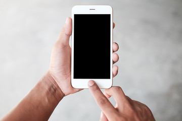 Cropped shot view of man hands holding smart phone with blank copy space screen for your text message or information content, female reading text message on cell telephone during in urban setting. 