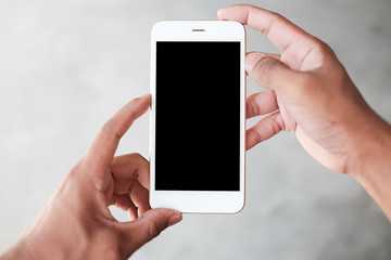 Cropped shot view of man hands holding smart phone with blank copy space screen for your text message or information content, female reading text message on cell telephone during in urban setting. 