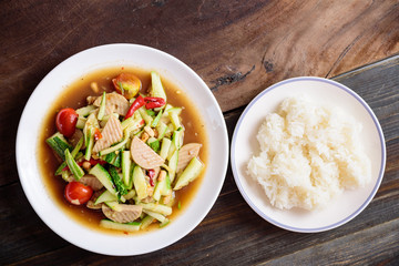 Spicy cucumber salad with sliced pork sausage and sticky rice, Thai food