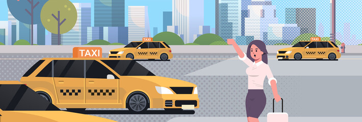 businesswoman catching taxi on street business woman in formal wear with luggage stopping yellow cab city transportation service concept cityscape background portrait flat horizontal © mast3r