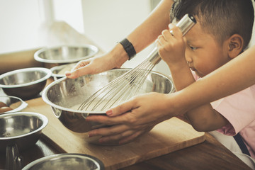 happy family in kitchen. family knead dough and bake the bakery together in kitchen