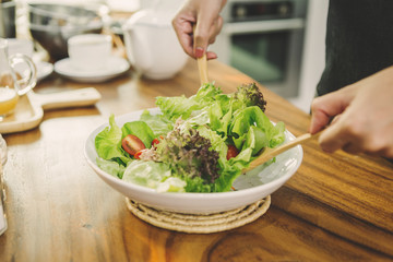 cooking man makes a salad in the morning in the kitchen