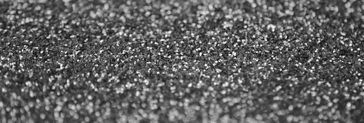 Silver decorative sequins. Background image with shiny bokeh lights from small elements