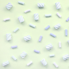 Colorful marshmallow laid out on lime paper background. pastel creative texture