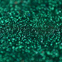 A huge amount of green decorative sequins. Background image with shiny bokeh lights from small...