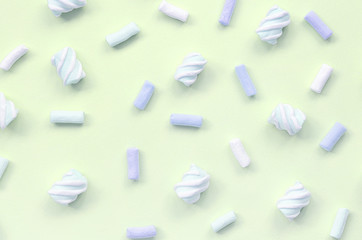 Colorful marshmallow laid out on lime paper background. pastel creative texture
