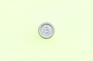 Metallic beer can on texture background of fashion pastel lime color paper