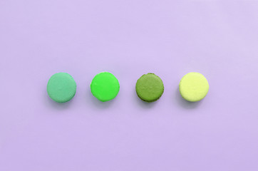 Dessert cake macaron or macaroon on trendy pastel lilac background top view